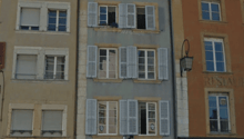 4-storey apartment building with balcony and entrance