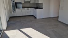 white cabinets, black countertops, silver faucet, white tiles, large glass windows