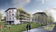 Two residential buildings, modern design, raised ground floor, multiple windows, balconies, green surroundings