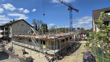 House under construction, scaffolding, crane, workers, yellow van, trees, houses, street light