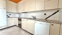 modern kitchen with white cabinets, granite countertops, dishwasher, washing machine, gas stove, wooden ceiling