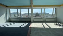 empty room, large windows, concrete floor, white walls, heating radiators