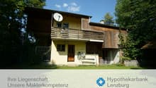 2 story house, wooden balcony, satellite dish, brick wall, garden