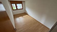 empty room, wooden floors, white walls, window, sun shining in
