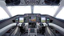 Cockpit dashboard with monitors, control panels, switches, and gauges.