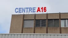 A multi-story commercial building with the text 'CENTRE A16' displayed prominently on the facade.