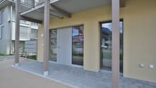 Modern building with glass doors, balcony, and mailbox