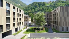 Modern apartment buildings, green space, walking paths, trees, mountains in the background