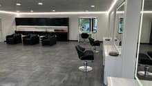 modern and clean salon with black seating and white countertops