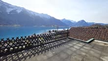 Roof terrace with a view of a lake and mountains