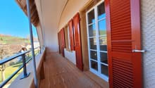 wooden floor, red shutters, glass doors, metal railings, view of the outside