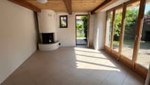room with fireplace, tile floor, wooden beams, sliding glass doors, white walls, recessed lighting