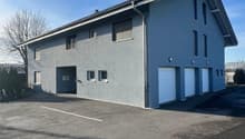 grey exterior, large windows, 3 garages, large parking space