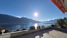 tiled floor, view of lake and mountains, shadow, railing, orange awning