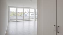 empty room, white tiles, large sliding glass doors, balcony, city view