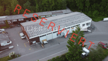 Industrial building with multiple parking spaces in front