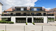 Modern 2-story house, white exterior, large glass windows, solar panels, balconies, garage