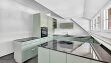 modern kitchen with green cabinets, granite countertops, built-in oven, sink, and faucet, large windows
