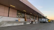 modern industrial building, metal awning, loading dock, truck in front