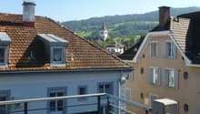 balcony, brown roof, windows, view of town