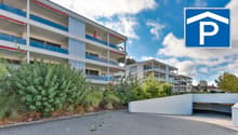 multi-storey building, balconies, underground parking, paved driveway