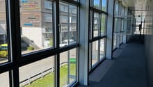 hallway with glass walls, windows with view to the outside