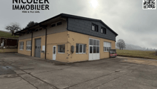 2 story house, concrete walls, white doors, garage, windows, cloudy sky