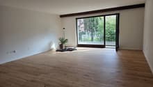 empty room, wooden floor, white walls, sliding glass door, balcony, potted plant, lamp