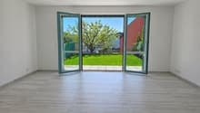 empty room, large glass doors, wooden floor, white walls, garden view