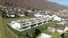 Modern apartment building, several units, swimming pool, greenery, mountainous landscape