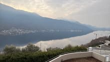 roof terrace with a lake view, mountains in the background, fenced