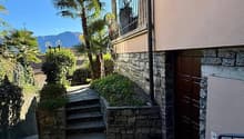 Stone wall, stone steps, balcony, palm trees, mountain view