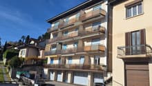 3-story house, beige exterior, multiple balconies, garage entrance, multiple garages