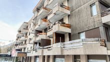 multi-story building, balconies, wood siding, concrete exterior