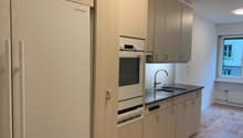 kitchen with wooden cabinets, granite countertop, sink, oven, dishwasher, fridge