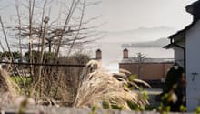 Overlook of a building, with a view of a lake and mountains.