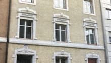 3 story house, beige walls, white windows, white door, multiple windows