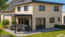 Two story house with beige walls, grey roof, covered outdoor seating area with a sofa, sliding glass doors