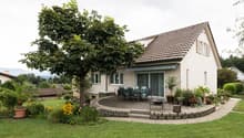 Detached house, brown roof, large tree, large garden, outdoor dining table, brick pathway