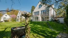 Modern house, white exterior, large windows, balcony, garden, fountain, lawn