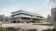 Modern office building, multiple stories, extensive use of glass facade, large driveway, multiple cars parked