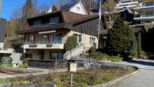 3-story house, brown roof, beige facade, several balconies, staircases