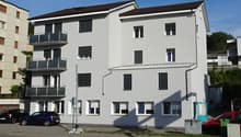 Modern building with 3 levels, glass windows, balconies, white paint, modern design, 3 balconies, black roof