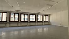 empty office room, white walls, large windows, gray floors, white ceiling