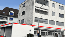 multi-story building, white walls, glass windows, streetlight, garage