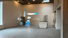 Open floor plan, exposed brick, concrete floor, skylight, large windows, modern kitchen, sink and faucet