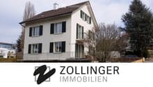 2-storey house, white walls, brown roof, 5 windows, balcony