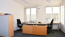 Empty office room, with three desks, two chairs, and cabinets
