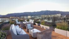 outdoor seating area, coffee table, flowerpots, mountain view