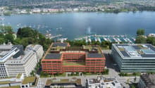 modern office building with solar panels, overlooking a large lake and a harbor
